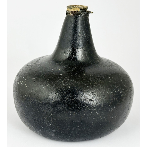 459 - ENGLISHJ ONION WINE BOTTLE. 5.7ins tall. Rim chips. Another heavy bottle the glass surface pitted & ... 