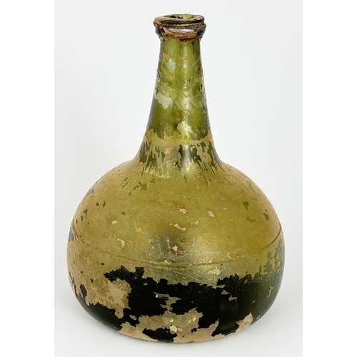 463 - DUTCH ONION WINE BOTTLE. 7.1ins tall. Green glass much covered with surface irridescence (flaking). ... 