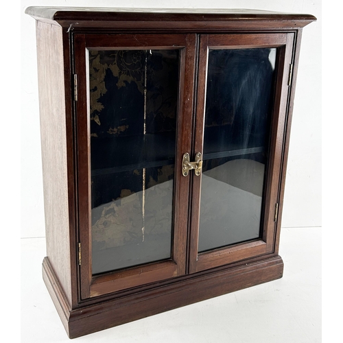 234 - FRONT OPENING DISPLAY CABINET. 21 x 24ins. Dark wood, double doors to front, 1 wooden shelf, crack t... 