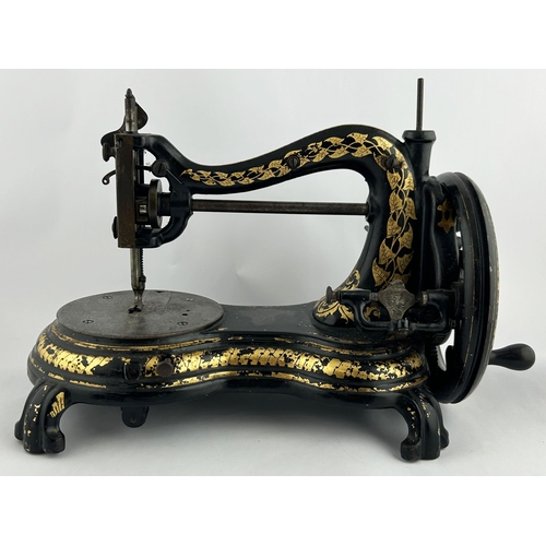 287 - SEWING MACHINE. 15 x 10ins. Black & gold decorative machine. Worn. 7/10 Unsuitable for p+p