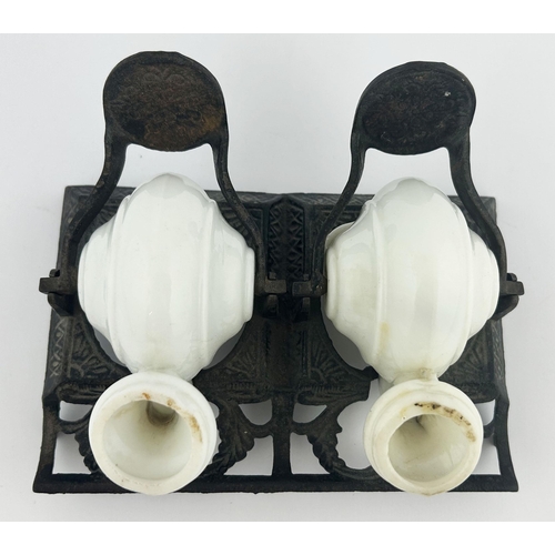 326 - DUAL SNAIL INKWELL. 3ins tall. Porcelain inkwells on metal stand. Damages to stand & repair to one o... 