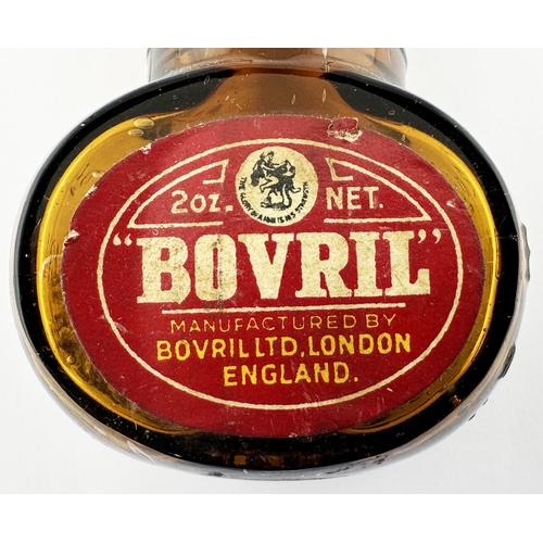 369 - BOVRIL BOTTLE. 3.2ins tall. Familiar amber glass shapely Bovril bottle, embossed to each side, and b... 