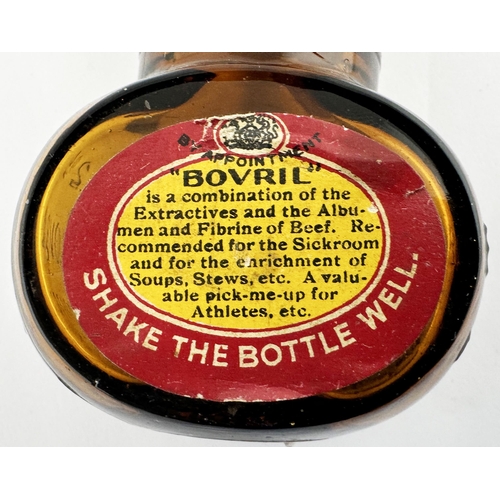 369 - BOVRIL BOTTLE. 3.2ins tall. Familiar amber glass shapely Bovril bottle, embossed to each side, and b... 