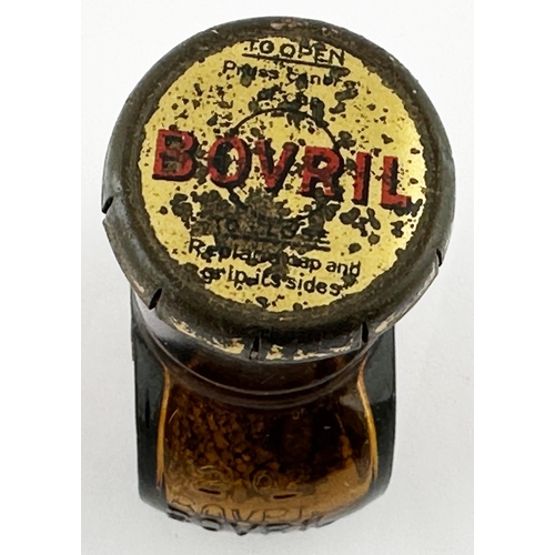 369 - BOVRIL BOTTLE. 3.2ins tall. Familiar amber glass shapely Bovril bottle, embossed to each side, and b... 