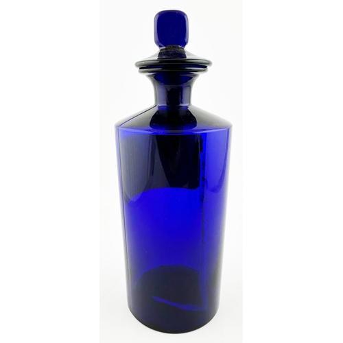 401 - PHARMACY SHOP ROUND BOTTLE. 10ins tall. Cobalt glass, point based glass stopper. Red & gold label un... 