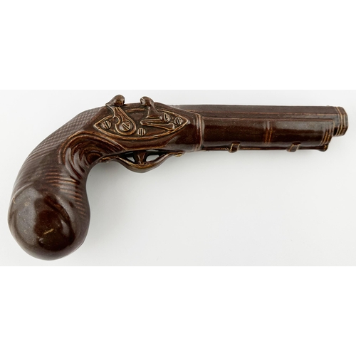 438 - DEWARS PERTH WHISKY PISTOL SHAPED FLASK. WG p57. Shiny brown glazed very detailed flintlock shaped f... 