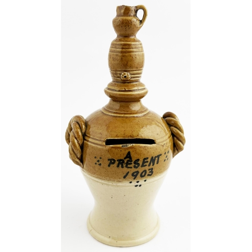 460 - stoneware money box topped with a jug and spigotted barrel shape, two rope effect side handles. Blac... 