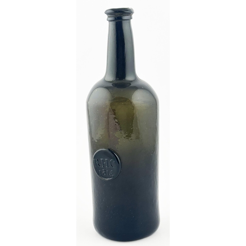 561 - 1815 SEALED DATED ENGLISH WINE BOTTLE. 11ins tall. Black/ dark green glass cylinder, crude double co... 