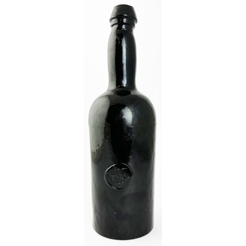 564 - T C SEALED THREE PIECE WINE BOTTLE. 11.3 ins tall. Black glass, 3 part mould, very winky/ crude neck... 