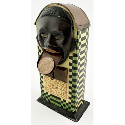 83 - BLACK PERSON HEAD TINPLATE MONEY BOX. 7.1ins tall. Multi coloured lithographed curved top money box,... 