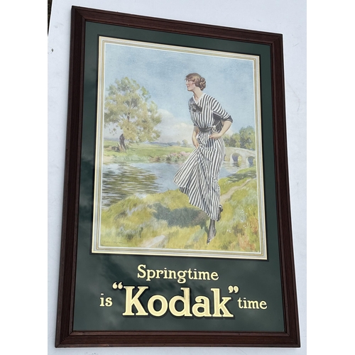 31 - KODAK FRAMED POSTER. 22.75 x 33ins. 1920 period original poster of lady by the river on glass. Gold ... 