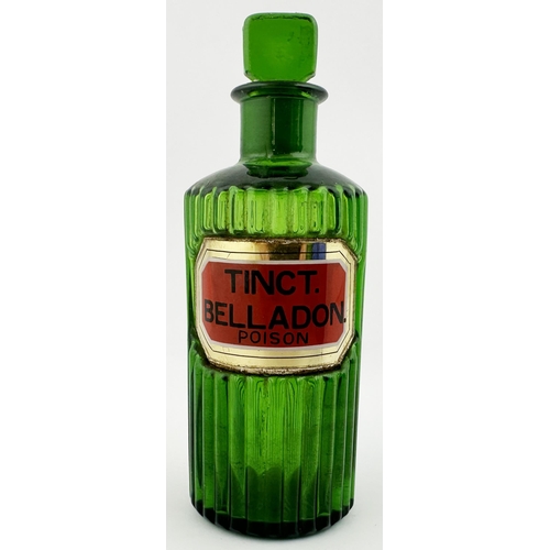 63 - RIBBED LABEL UNDER GLASS SHOP ROUND BOTTLE. (DP p153). 5.9ins tall. Bright green glass, inset affixe... 