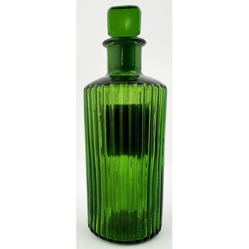 63 - RIBBED LABEL UNDER GLASS SHOP ROUND BOTTLE. (DP p153). 5.9ins tall. Bright green glass, inset affixe... 