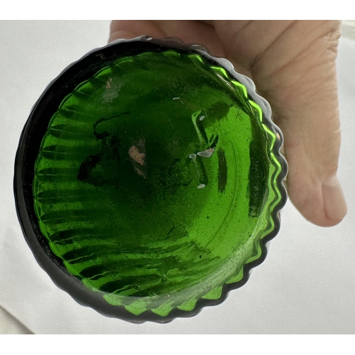 63 - RIBBED LABEL UNDER GLASS SHOP ROUND BOTTLE. (DP p153). 5.9ins tall. Bright green glass, inset affixe... 