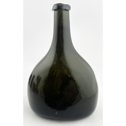 161 - . ENGLISH BLADDER WINE BOTTLE. 8.1ins tall. Black, very dark green, glass, flat ovoid base shape wit... 