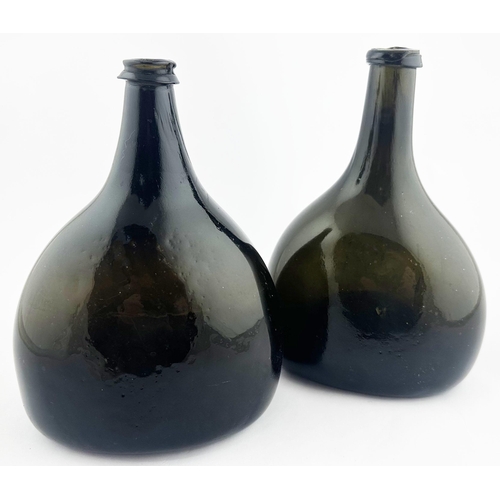 161 - . ENGLISH BLADDER WINE BOTTLE. 8.1ins tall. Black, very dark green, glass, flat ovoid base shape wit... 