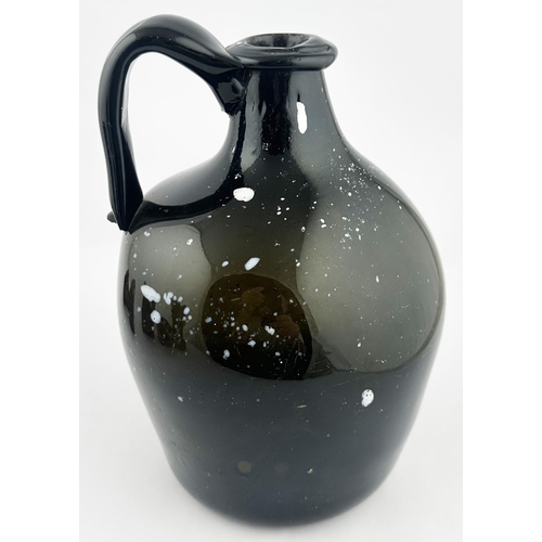 163 - NAILSEA GLOBULAR HANDLED JUG. 8.9ins tall. Familiar black, very dark green, glass with additional wh... 