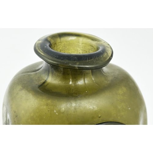 168 - LONDON SEALED UTILITY BOTTLE. 4.5ins tall. Very dark olive gree glass. Rectangular form with canted/... 