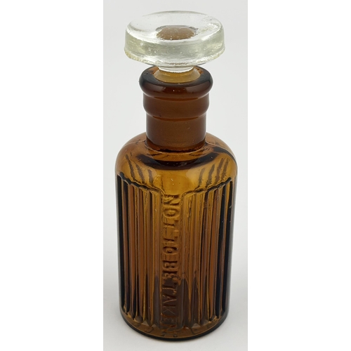 1 - BAILEY POISON BOTTLE. 3.3ins tall. (DP p67). Brown glass cylinder, sturdy flat topped clear glass gr... 