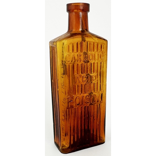 27 - CARBOLIC ACID POISON BOTTLE. 6ins tall. (DP p145) Amber glass, rectangular shape with embossing on t... 