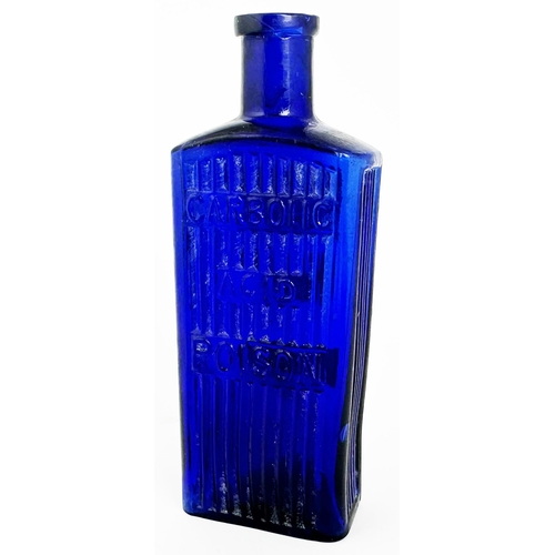 28 - CARBOLIC ACID POISON BOTTLE. 6ins tall. (DP p145) Cobalt blue glass, rectangular shape with embossin... 