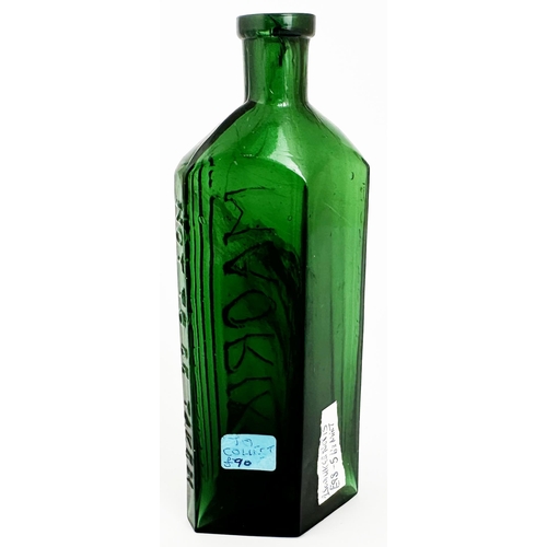 29 - MAORIX EMBROCATION BOTTLE. 6.3ins tall. (DP p39) Green glass, rough diamond shape with slim side edg... 