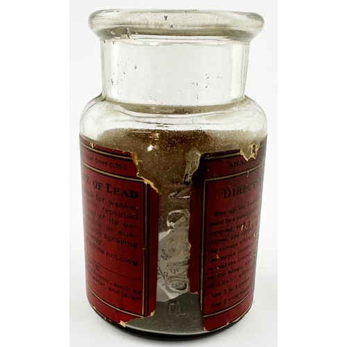 39 - BOSTON POISON BOTTLE. 4.75ins tall. Clear glass jar with paper label SWIFTS/ POISON/ ARSENATE OF/ LE... 