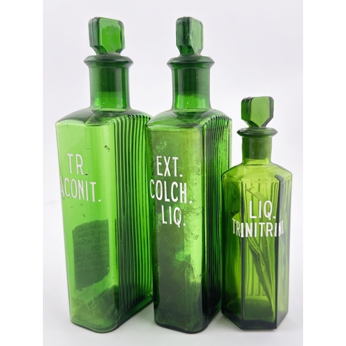 82 - CHEMIST BOTTLE TRIO. Tallest 6.75ins. Two rectangular, one hexagon shape with stoppers. Enamelled le... 