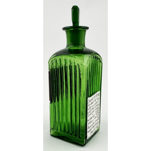 481 - PHARMACY SQUARE SHOP BOTTLE. 5.8ins tall. Bright green glass, square body, green chisel stopper, ver... 