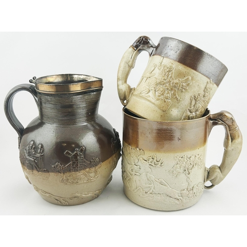 11 - STONEWARE TRIO. Tallest 8ins. Two heavily sprigged tankards plus pewter rimmed jug. Damages. (3) 8.0... 