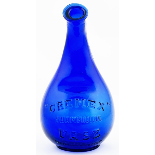 31 - CREMEX SHAMPOOING VASE. 7.5ins tall. Cobalt blue, embossed. Slight roughness to lip.