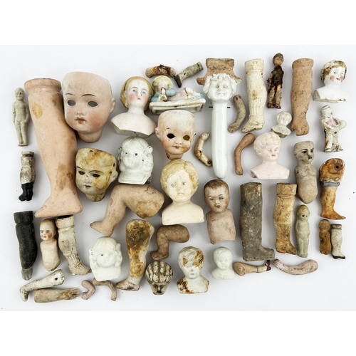 426 - DOLLS HEAD & PARTS GROUP. Largest 4.5ins. Various size heads, legs, arms plus others. Damages. (47) ... 