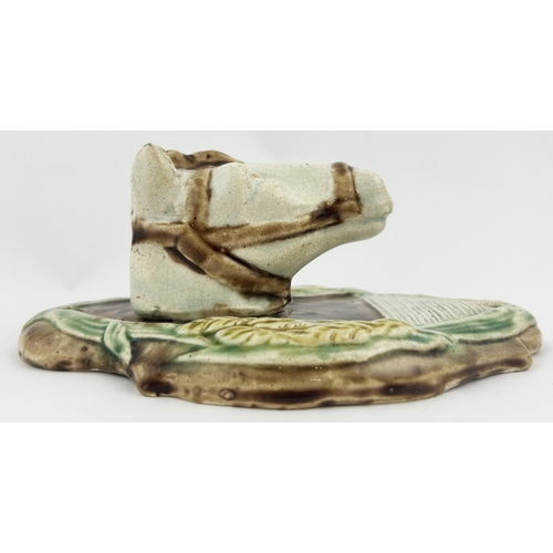 43 - HORSE HEAD MATCH HOLDER/ STRIKER. 6.25ins. Porcelain made with corn motifs at either side. Hairline ... 