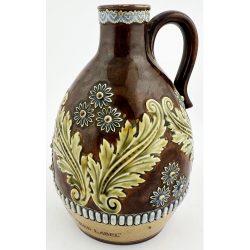 560 - BURY ST EDMUNDS WHISKEY JUG. WG p147. 7ins tall. Decorative floral & leafy artware jug. Black transf... 