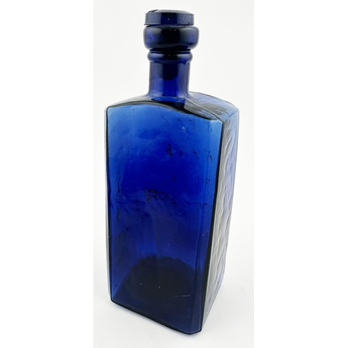 597 - GLYCERINE PURE DISTILLED BOTTLE. 8ins tall. Wonderful dark blue glass wedge shape looking much like ... 