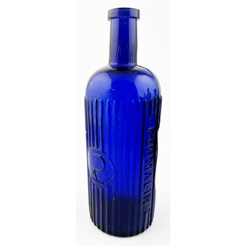 644 - FORMALIN POISON BOTTLE. 8.3ins tall (20oz capacity). Cobalt blue glass. Vertically ribbed with hand ... 