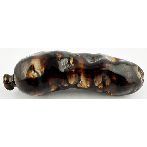 676 - STAFFORDSHIRE POTTERY POTATO SPIRIT FLASK. 7.5ins long. Shiny brown treacle glaze. Small chip. Varie... 