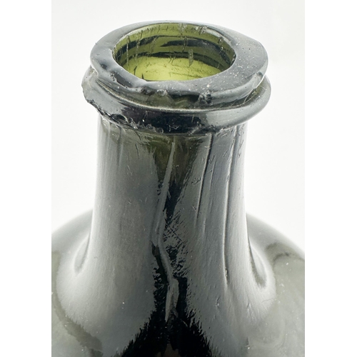 705 - ENGLISH MALLET WINE BOTTLE. 7ins tall. A noticeably dark black/ dark olive green glass to what is no... 