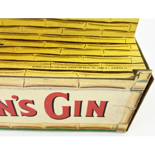 125 - GORDONS GIN ADVERTISING FIGURE. 11.4 x 12.5ins. An extraordinary multi coloured card, feather & what... 