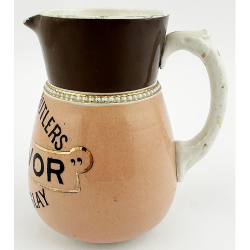 199 - MITCHELLS & BUTLERS CLAN IVOR OLD SCOTCH ISLAY WHISKY WATER JUG. 4.6ins tall. Pink body, black three... 