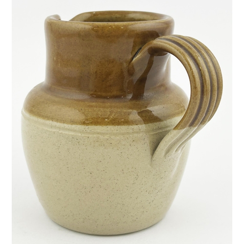 200 - ILISKA SPECIAL SCOTCH WHISKY WATER JUG. 4ins tall, mid brown top, lower off white. An unusual stonew... 