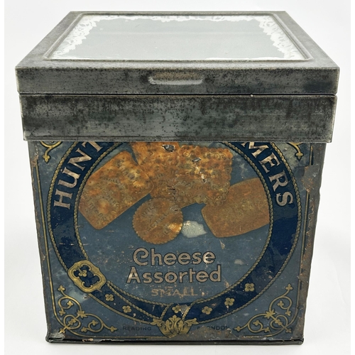 54 - HUNTLEY & PALMERS CHEESE ASSORTED BISCUIT TIN. 10.3 x 9.2 x 8.5ins. Hinged metal framed lid, glass t... 