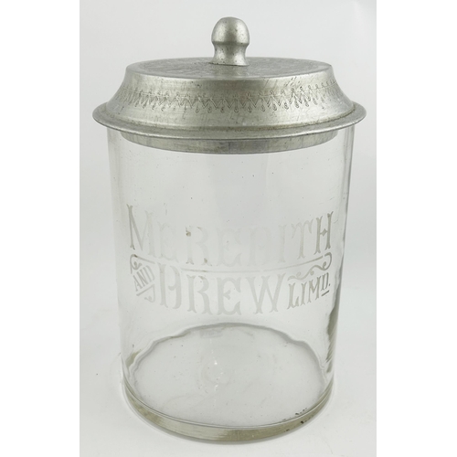 61 - LIDDED MEREDITH & DREW BISCUITS JAR. 9.4ins tall. Clear acid edged straight sided jar with light met... 