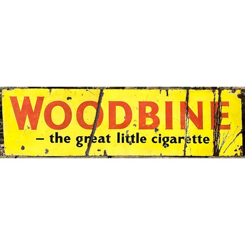 260 - WOODBINE THE GREAT LITTLE CIGARETTE ENAMEL SIGN. 60 x 17ins. Yellow with red lettering. Rust patches... 