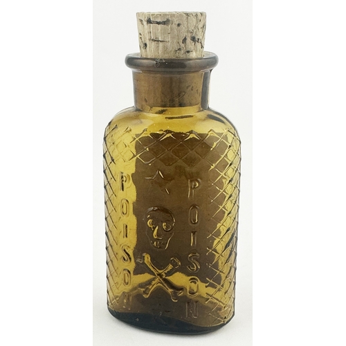 355 - CONTINENTAL LABELLED POISON BOTTLE. 4.5ins tall. Honey coloured glass featuring embossed skull & cro... 