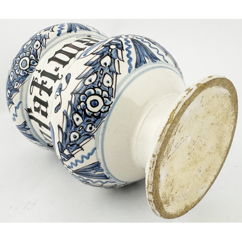 371 - TIN GLAZED DELFT STYLE DRUG JAR. 6.3ins tall. Squat dumbbell shape, hand decorated in blue & black, ... 