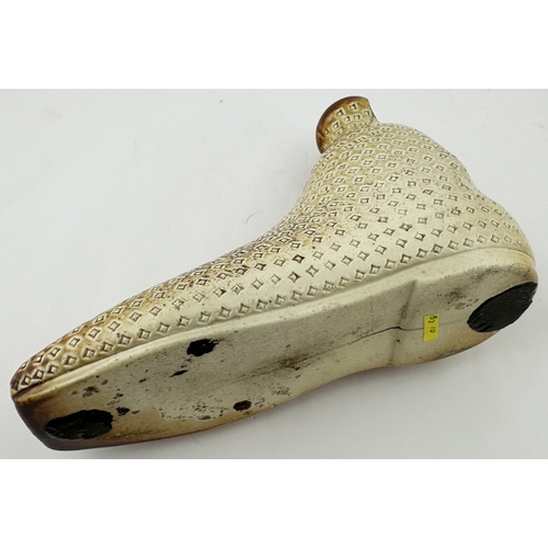 384 - SHOE SHAPED SPIRIT FLASK DUO. Largest 5.iins tall, 6.8ins long. Salt glazed pair of shoes, each with... 