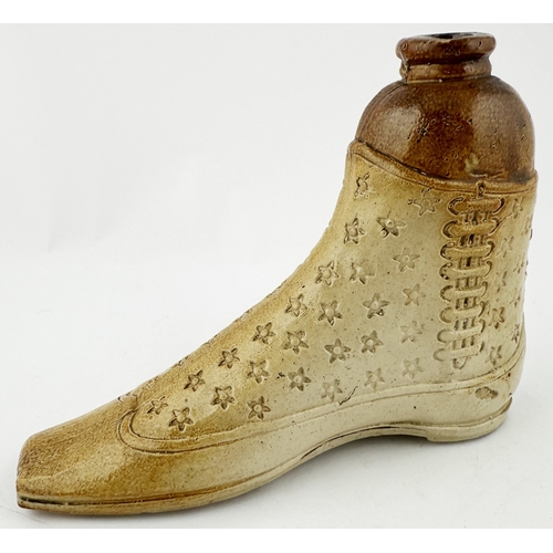 384 - SHOE SHAPED SPIRIT FLASK DUO. Largest 5.iins tall, 6.8ins long. Salt glazed pair of shoes, each with... 