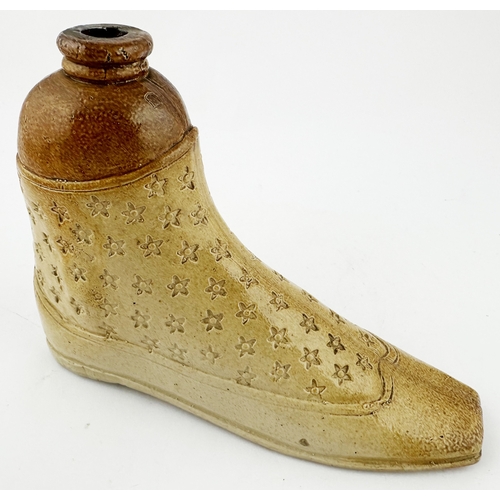 384 - SHOE SHAPED SPIRIT FLASK DUO. Largest 5.iins tall, 6.8ins long. Salt glazed pair of shoes, each with... 