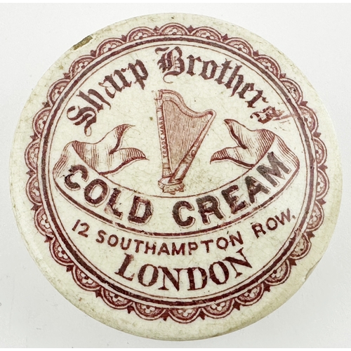 410 - LONDON COLD CREAM POT LID. (APL p388, 32) 2.6 ins diam. Red transfer large harp pict to centre decor... 